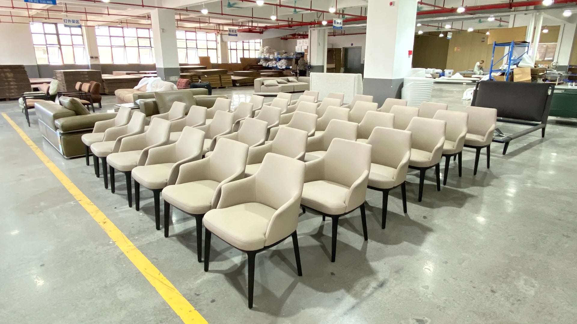 Row of beige chairs in a warehouse setting