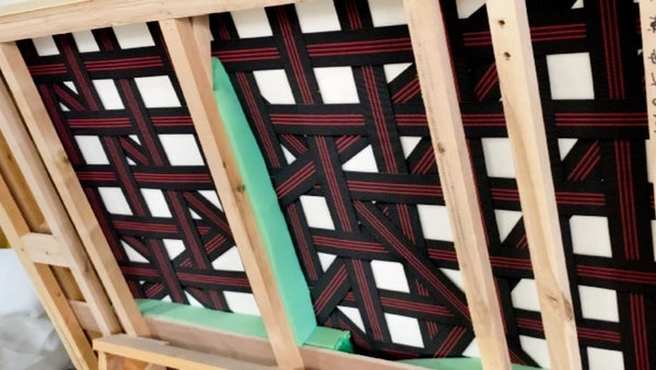 Wooden chair with a patterned cushion on a white background