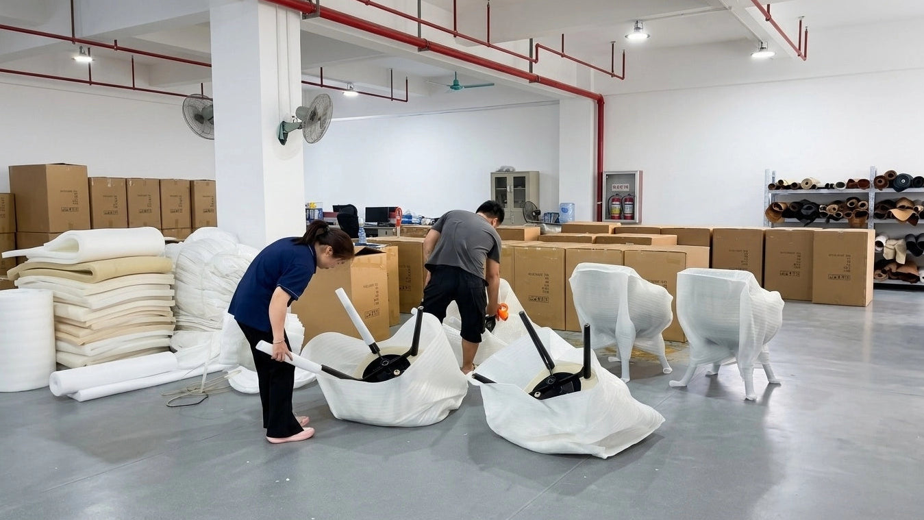 Two people working with white chairs in a warehouse setting.