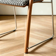 Puwabi X6209 solid ash and stainless steel dining armchair with a modern design, shown from the front side.
