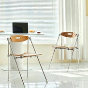 Puwabi X6198 architectural folding dining chair with wooden frame and fabric seat, designed for modern contract use.