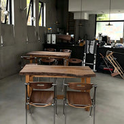 Puwabi X6198 architectural folding dining chair with wooden frame and cushioned seat, arranged in a modern dining setting