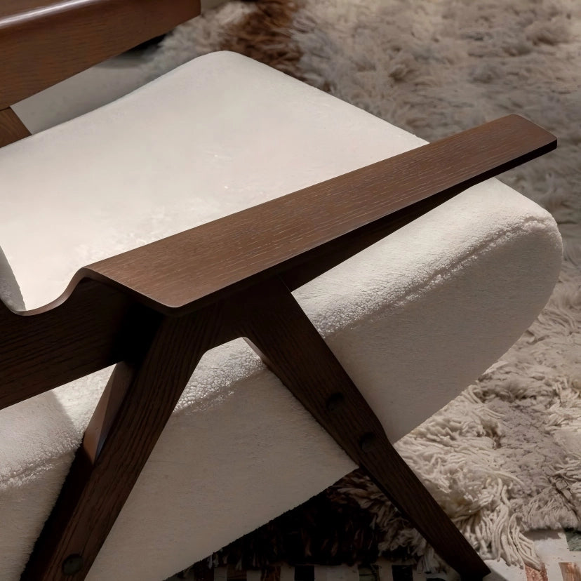 Wooden chair with white cushion on a textured surface
