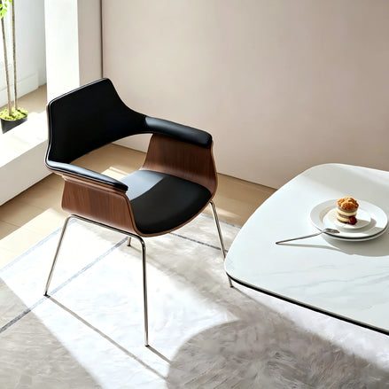 Puwabi X6119 sculptural bentwood contract dining armchair with curved wooden design and armrests, set against a neutral background.