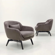 Two gray armchairs with black legs on a white background
